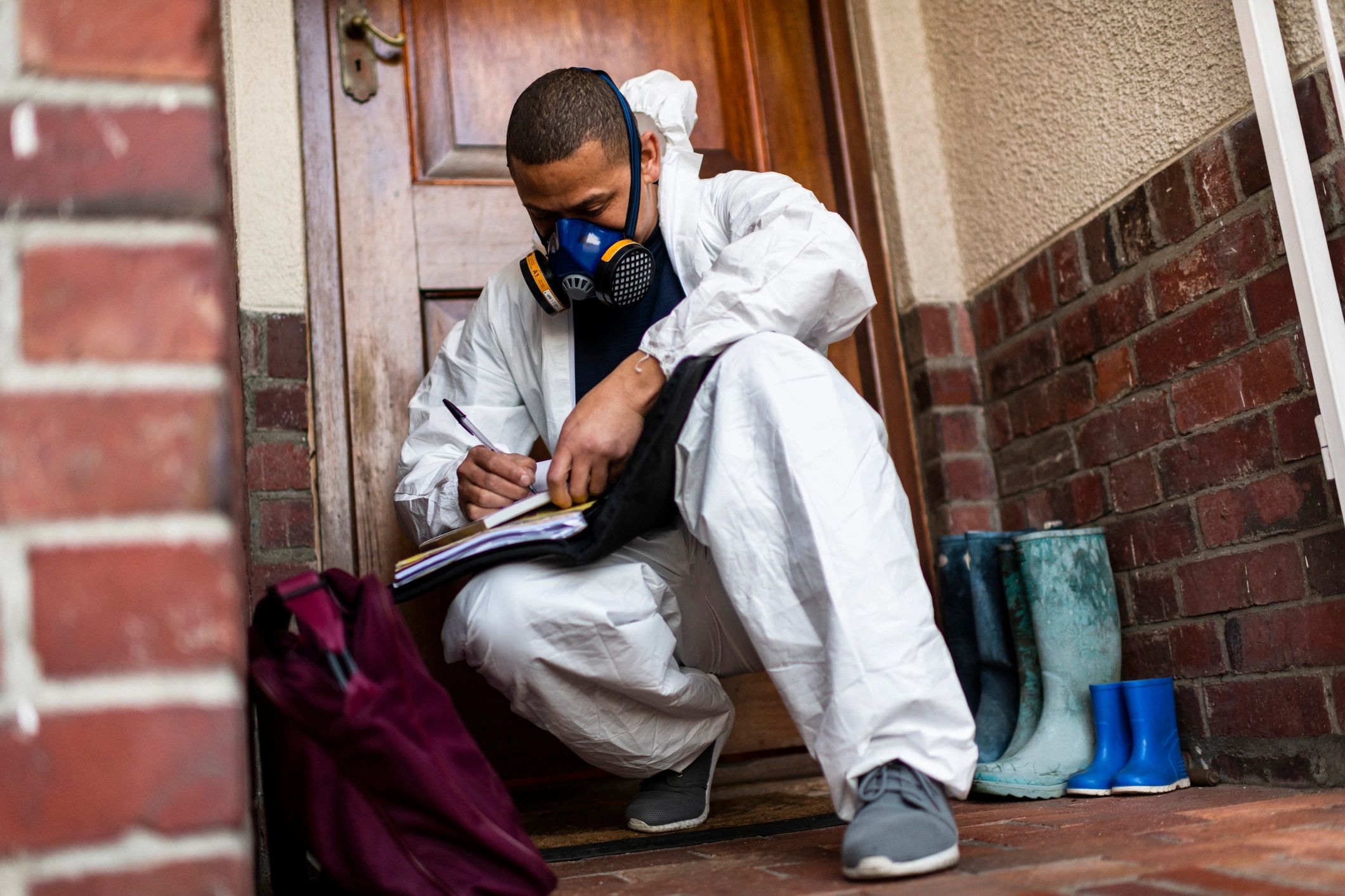Pest control technician outside a residential property